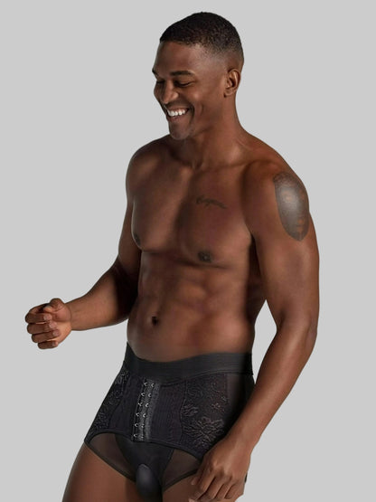 Man wearing black underwear on a plain background